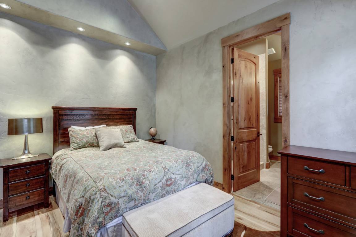 Bedroom Interior With Grey Plaster Venetian Wall Finish And Cow Skin On The Floor.